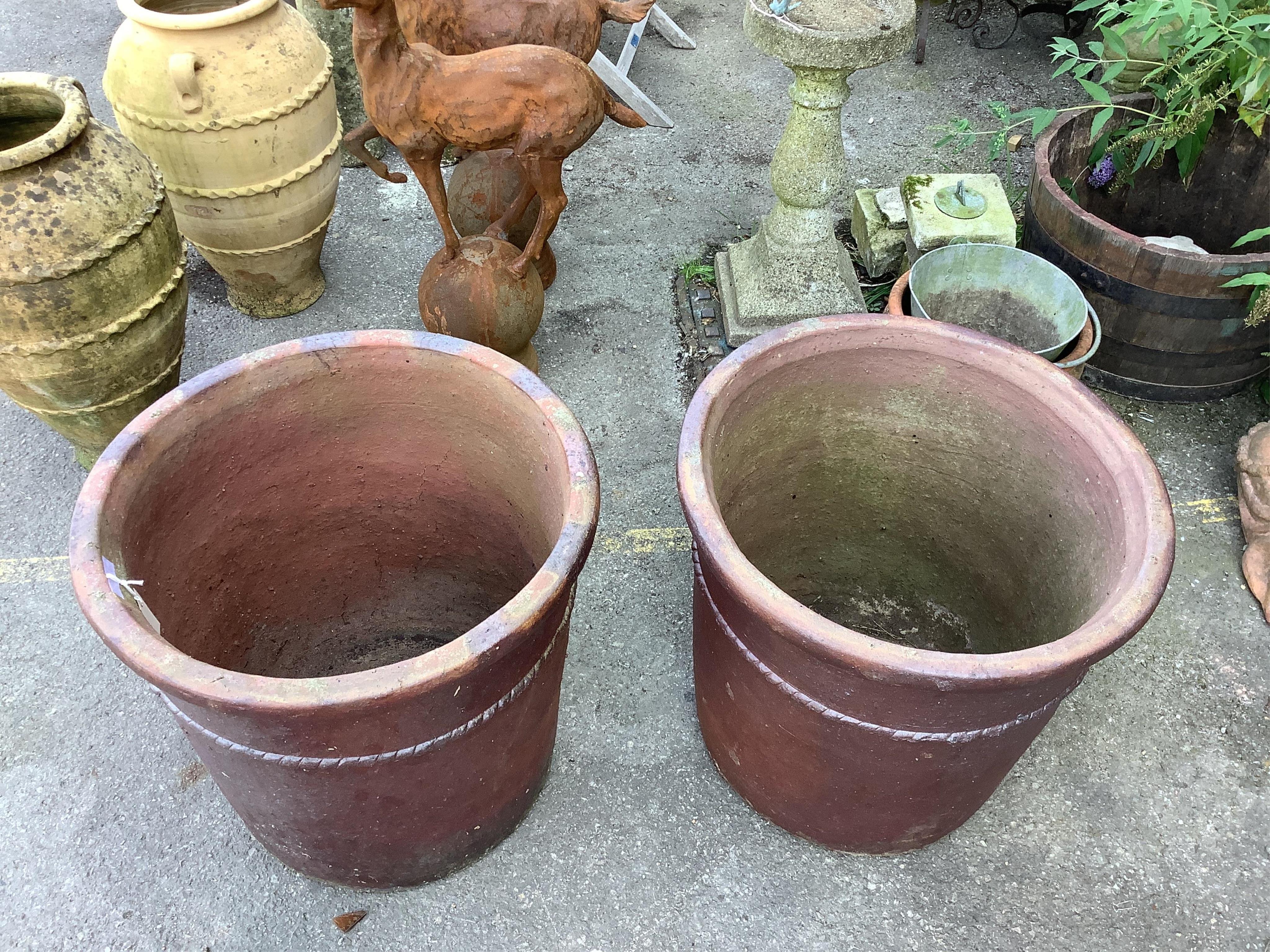 A large pair of brown glazed pottery garden urns, diameter 58cm, height 57cm. Condition - weathered, otherwise good